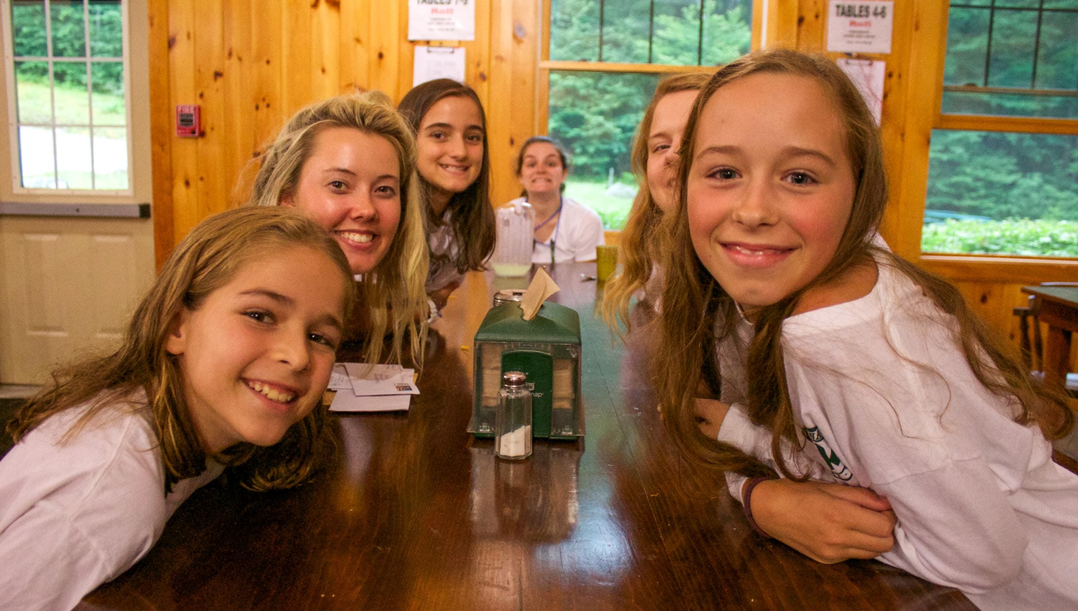 Girls and staff at dining hall table