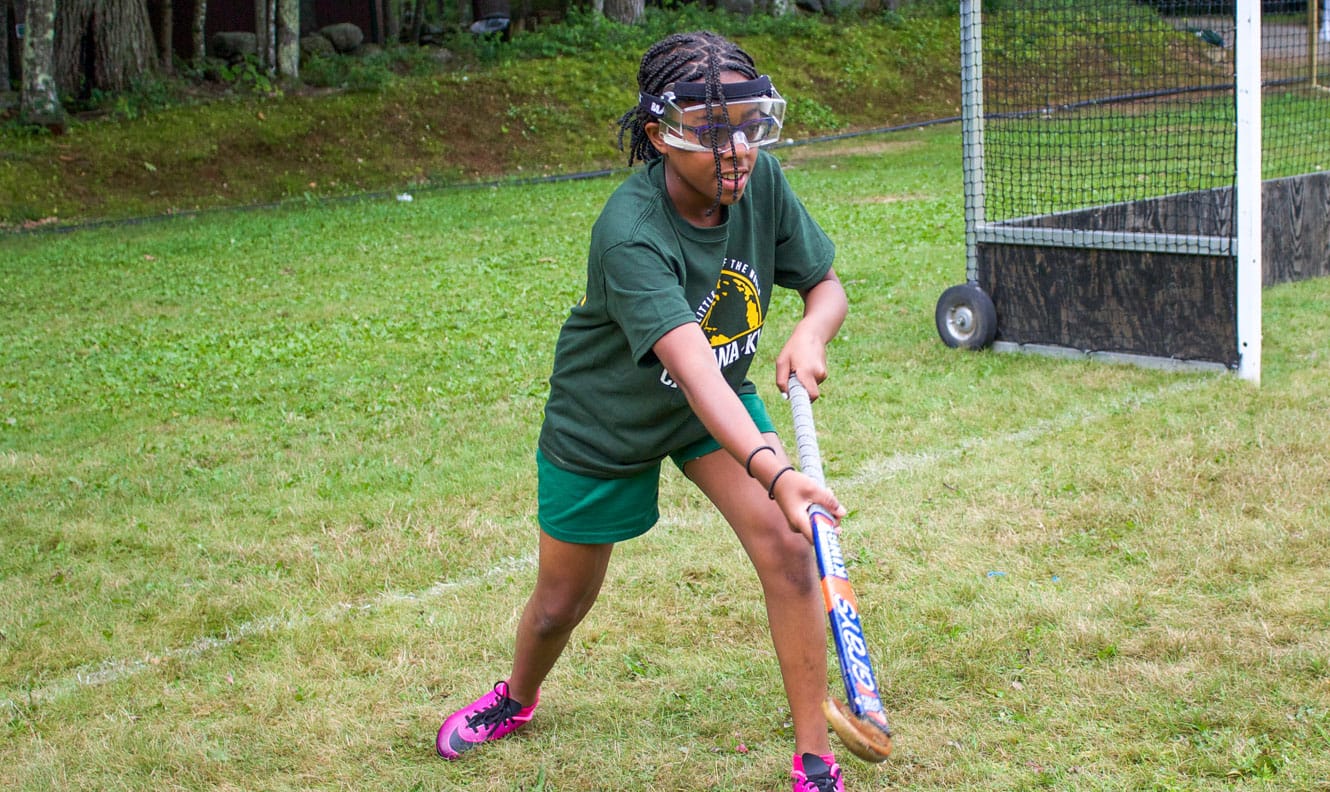 Girl playing field hockey