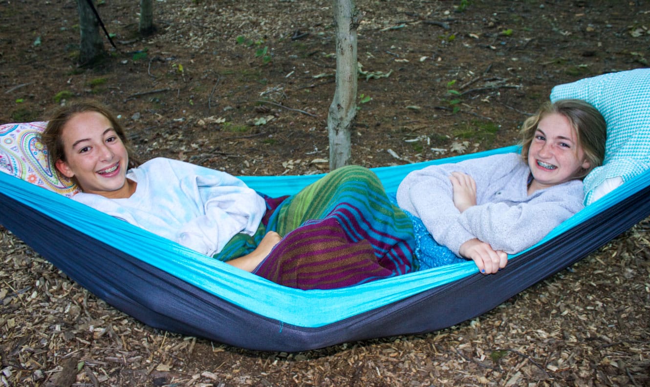 Two girls laying on a hammock