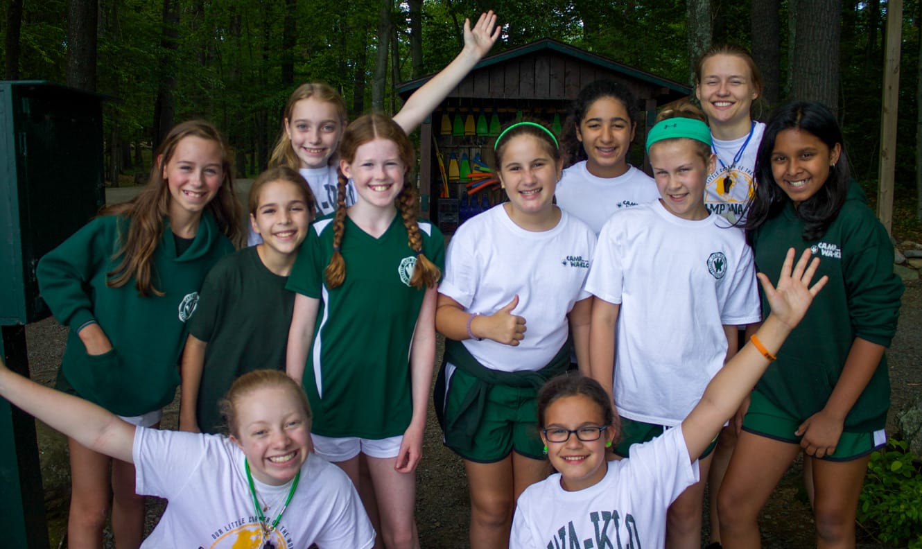 Group of smiling girls with staff