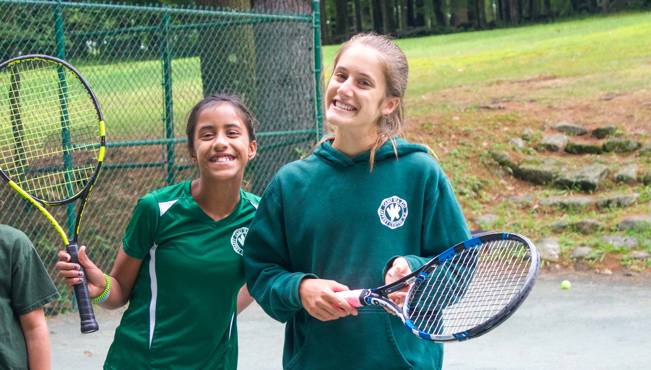 Camper and staff during tennis