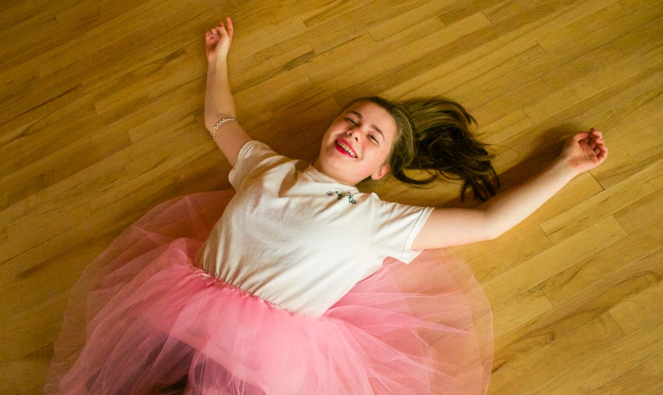 Girl in tutu laying on floor