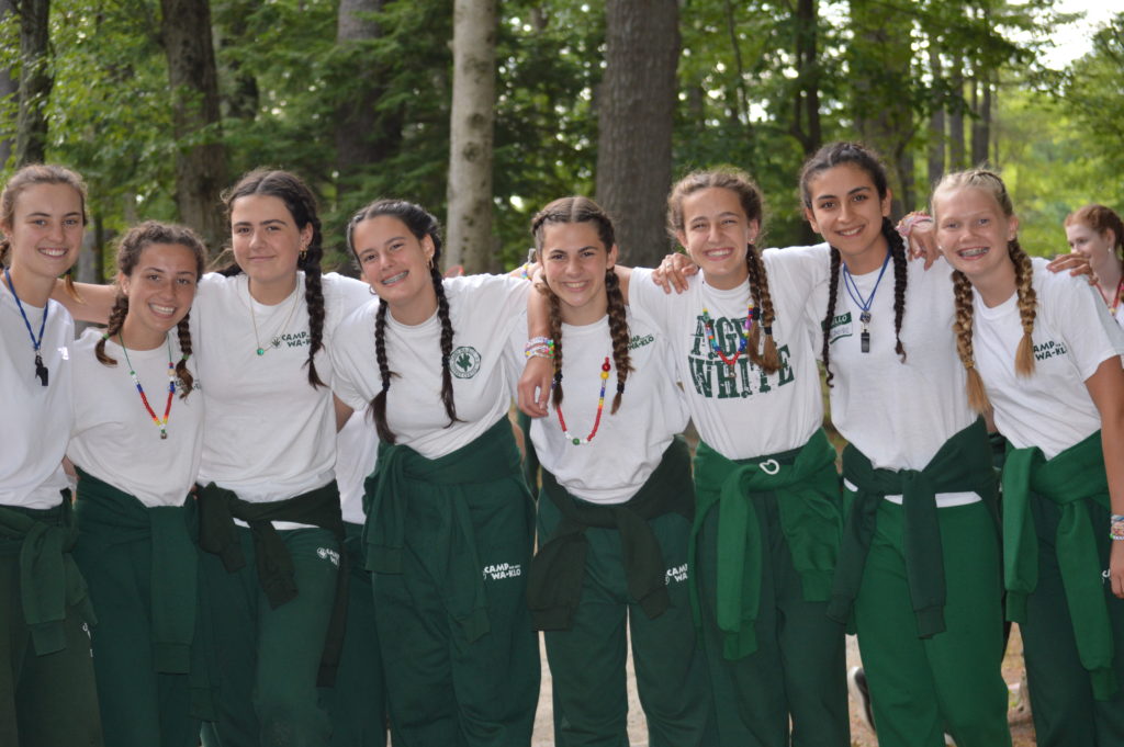 Photograph of senior campers dressed for campfire wearing their beads.