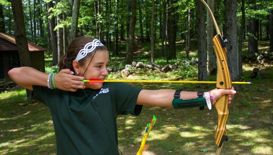 Girl shooting an archery arrow