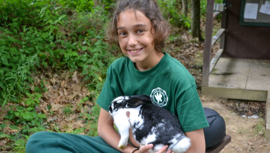 Camper holding bunny at pet care