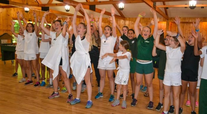 Girls doing a cheer in the dining hall