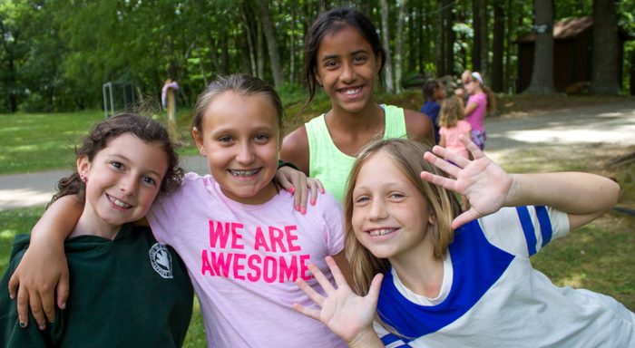 Four first time campers smiling