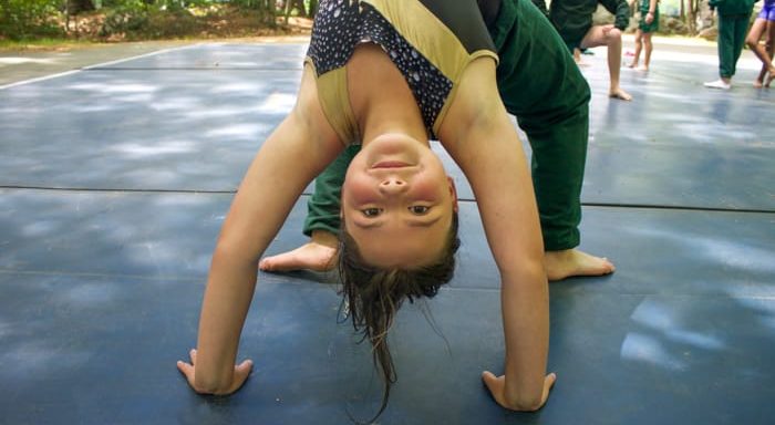 Girl doing the bridge pose in gymnastics