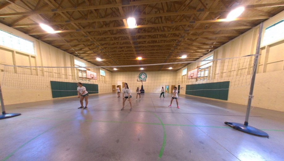 Girls playing volleyball indoors
