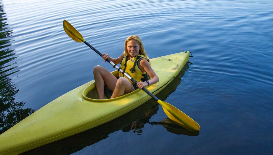 Camper in yellow kayak