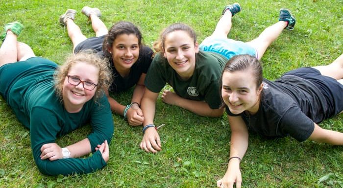 Four girls laying on the grass