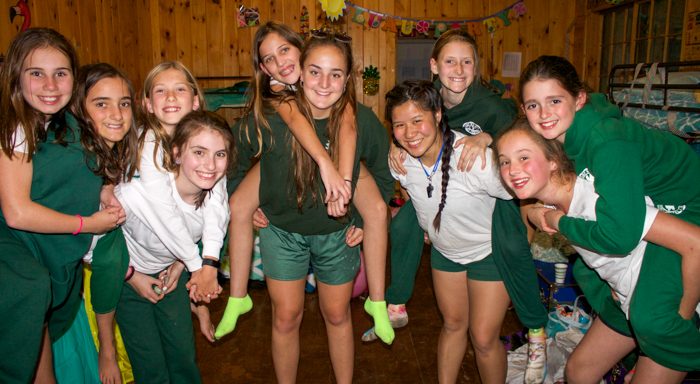 Campers piggybacking on staff in cabin