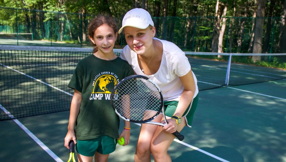 Young camper and staff during a private tennis lesson