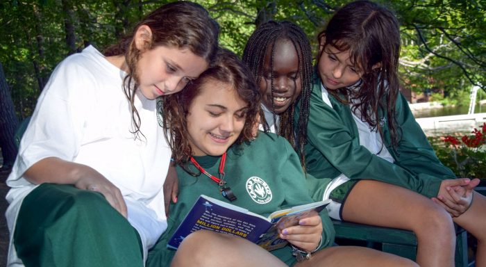 Staff reading to campers