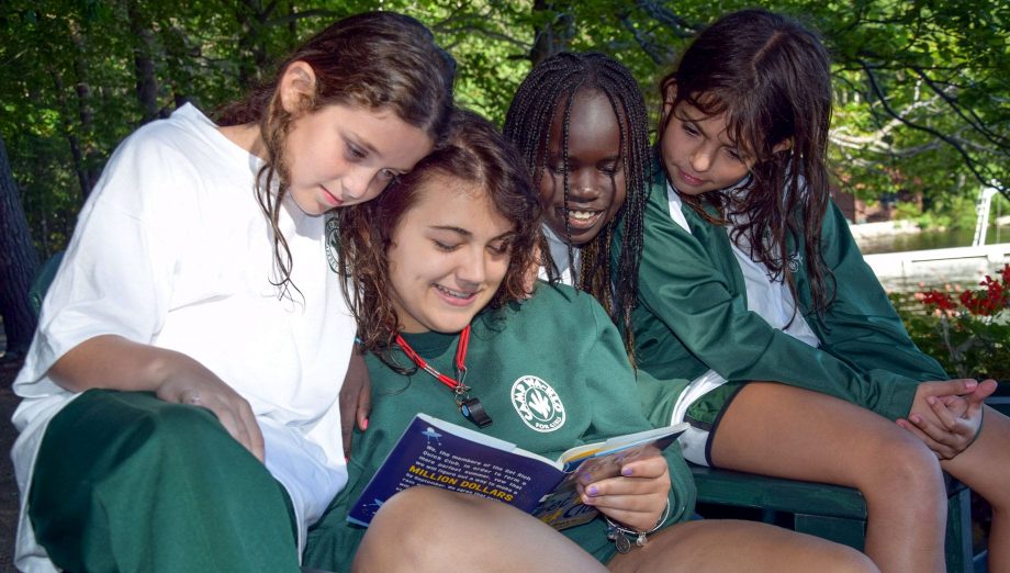 Staff reading to campers