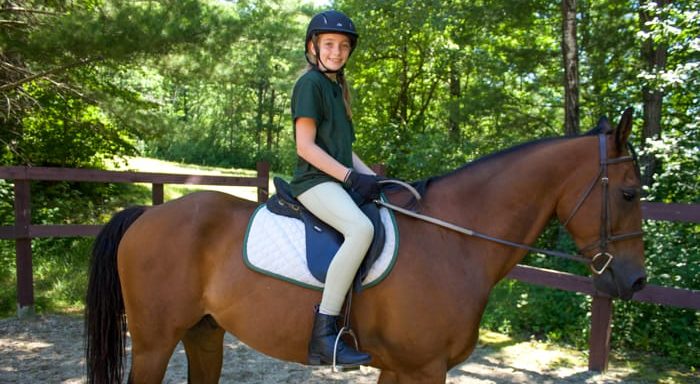 Camper riding a horse