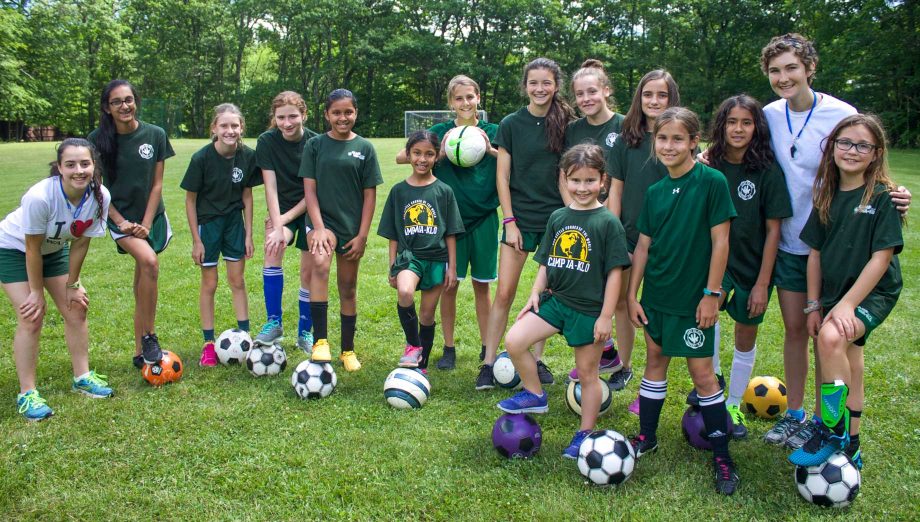 Large group of girls with soccer balls