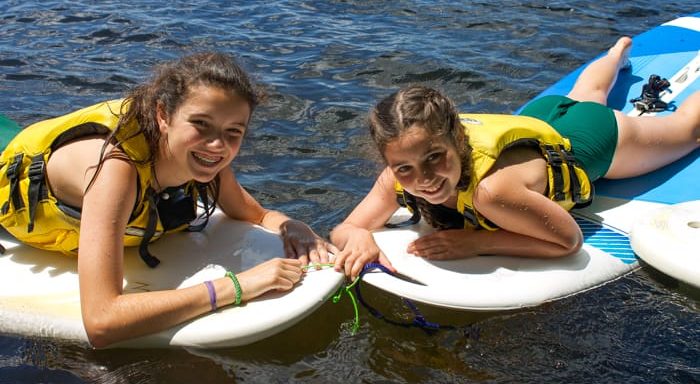 Two girls on stand up paddle boards